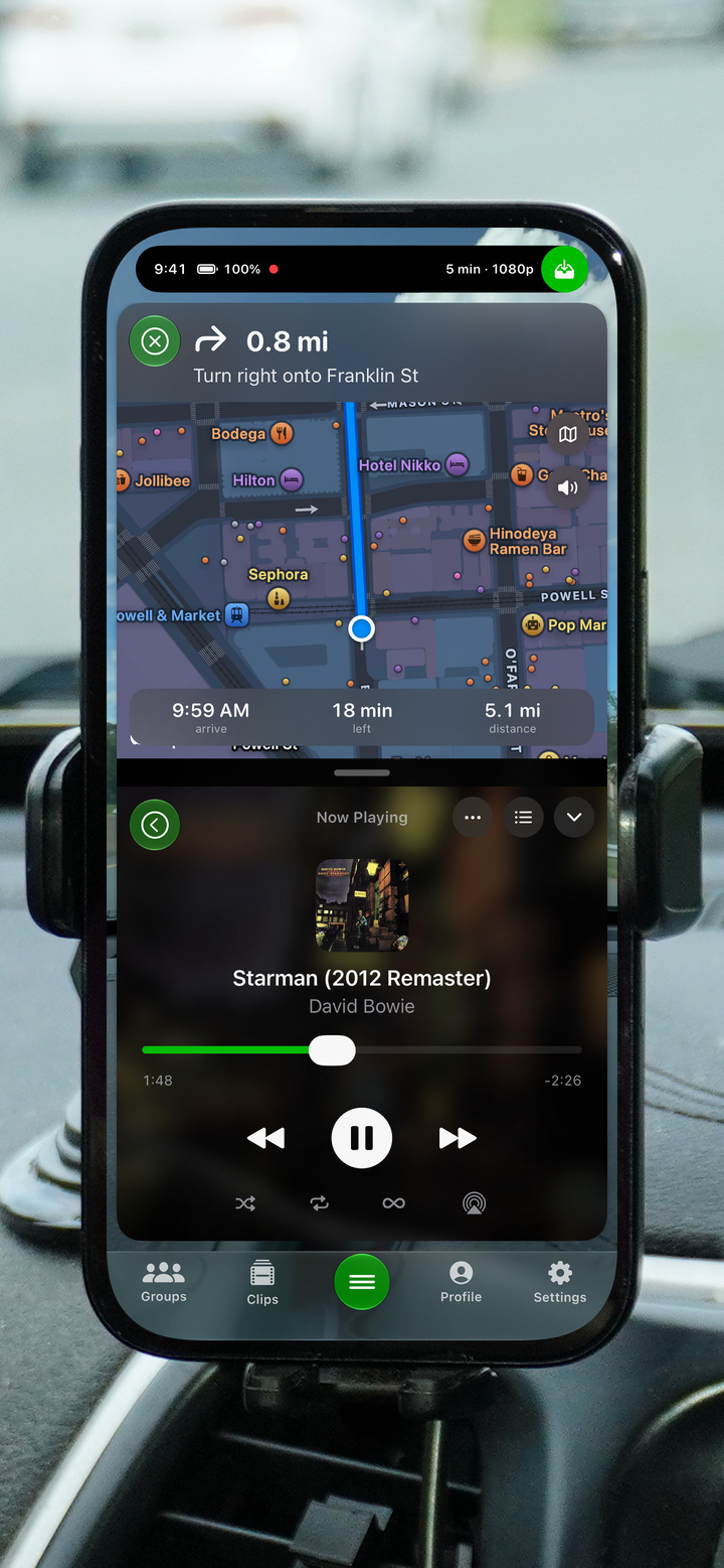 GoDash in a car mount showing turn-by-turn navigation above the Now Playing music player